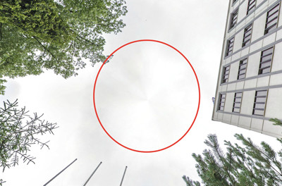 A conical spot on a spherical panorama of a street